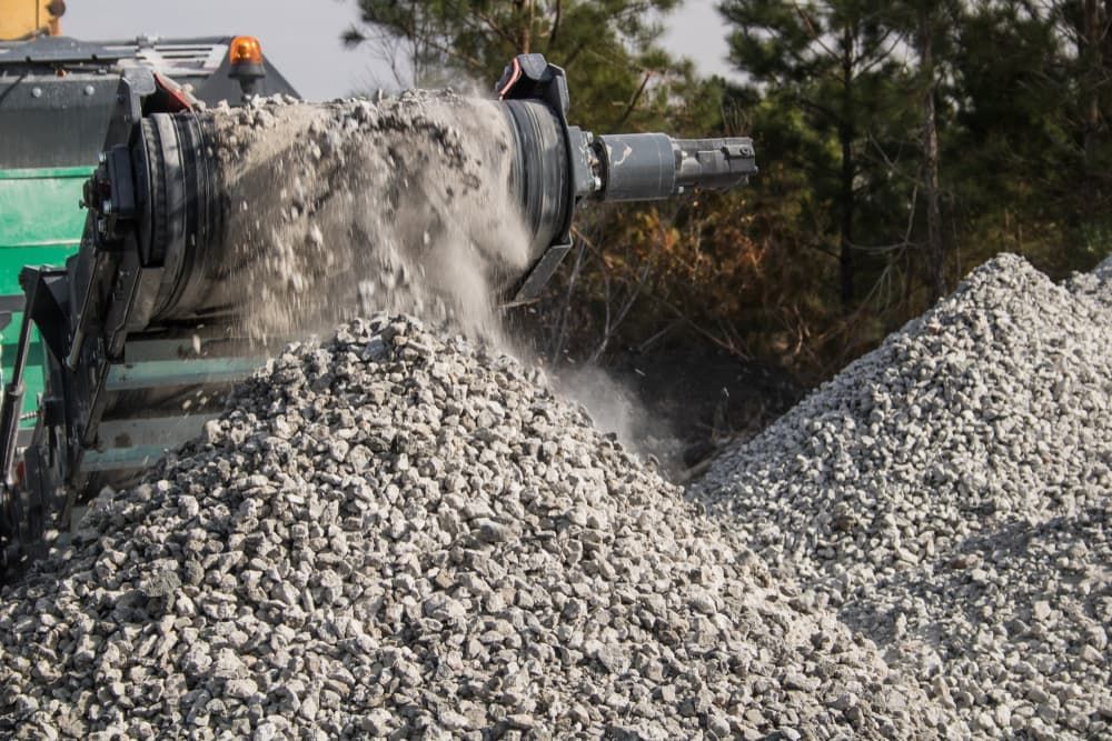 A Pile of Gravel Is Being Poured from A Machine — Albury Demolitions in Lavington, NSW