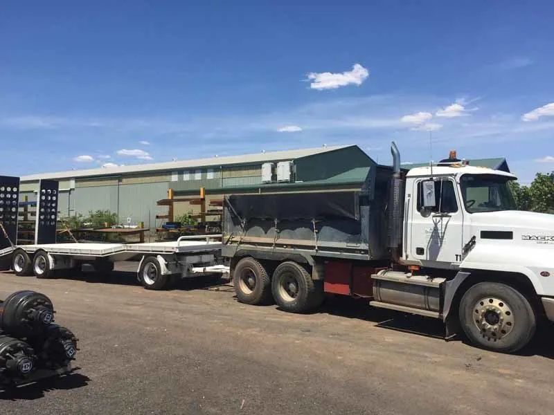 A Dump Truck with A Trailer Attached to It Is Parked in A Parking Lot — Albury Demolitions in Lavington, NSW