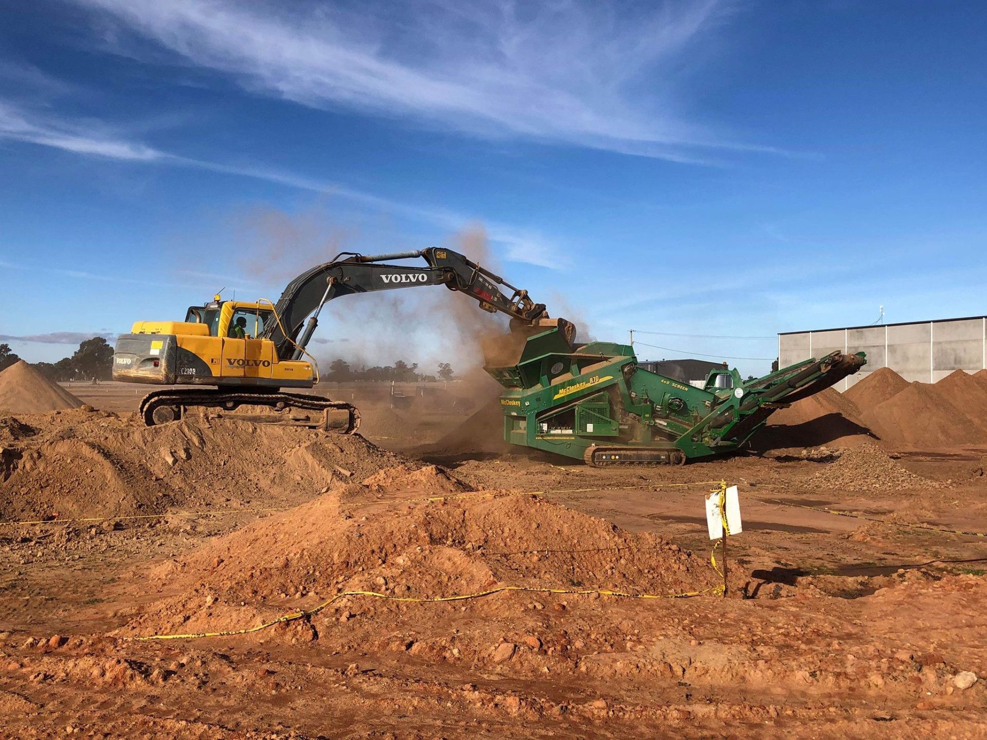 A Bulldozer Is Digging a Hole in The Ground — Albury Demolitions in Bright, NSW