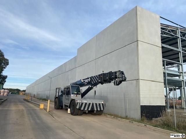 View of a crane parked beside a job site.