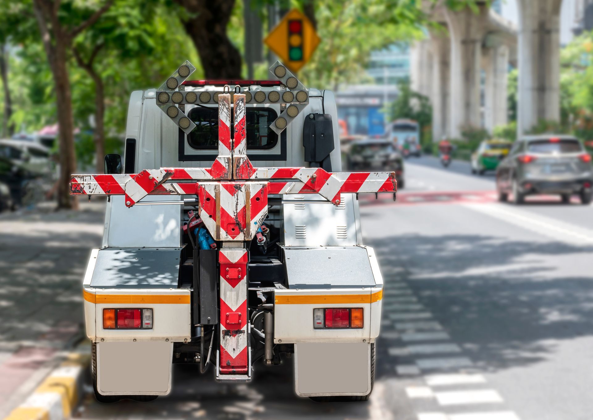 24 hour towing truck with red reflective lift parked on city street in daylight. 24 hour towing truck with red reflective lift parked on city street in daylight.