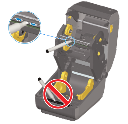 Inside of a thermal label printer showing two yellow media holders and a movable sensor labeled