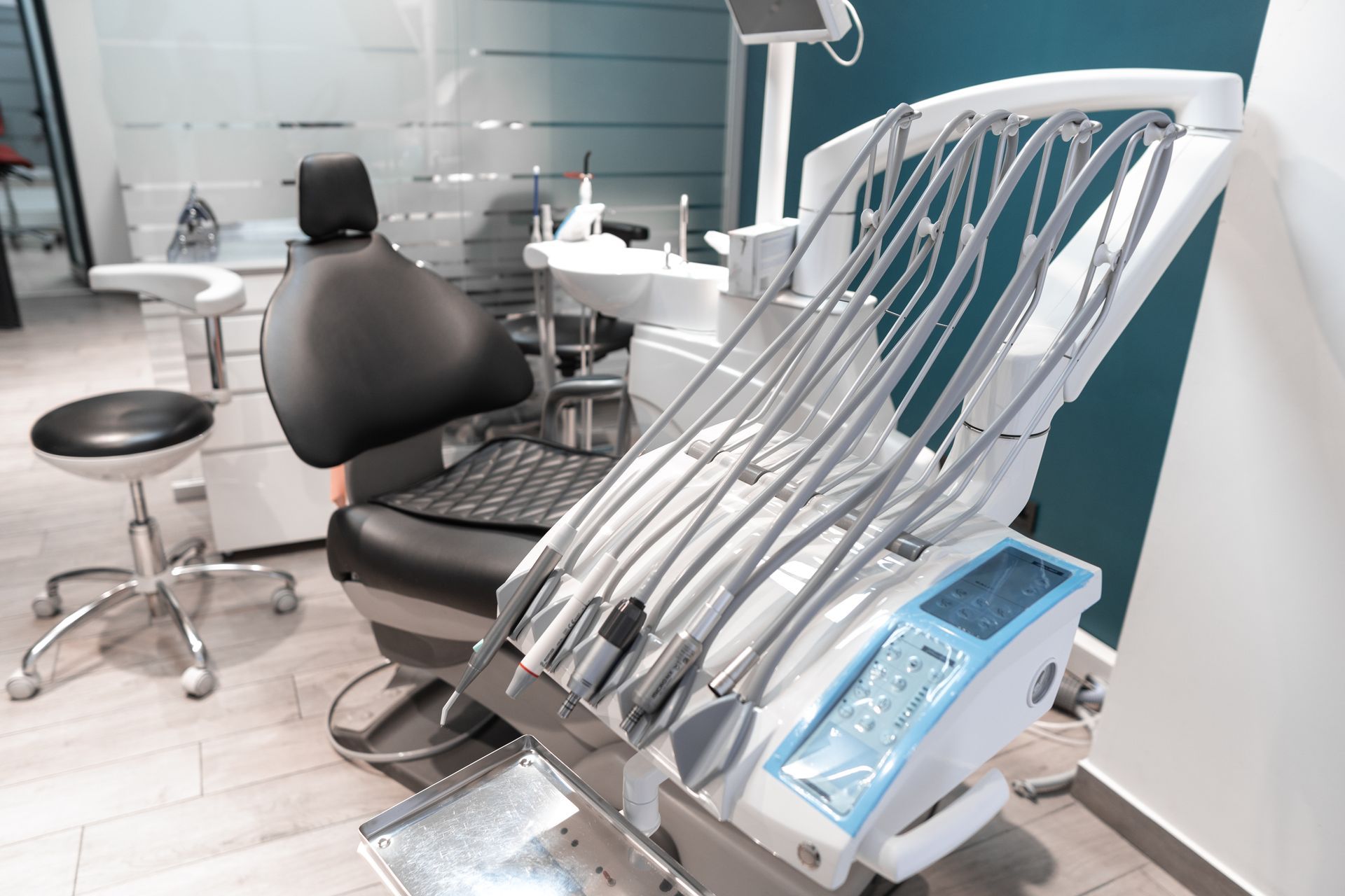 Dental chair with multiple instruments in a modern clinic treatment room