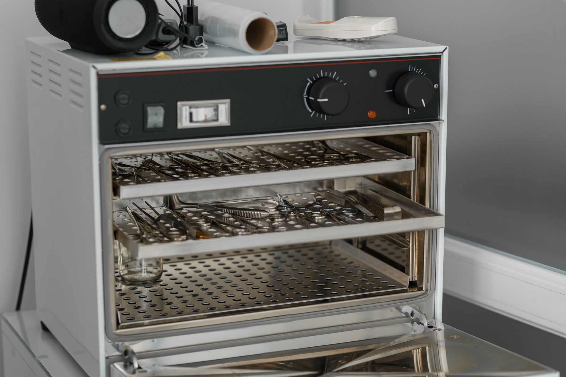 Countertop food dehydrator with three metal trays in a kitchen