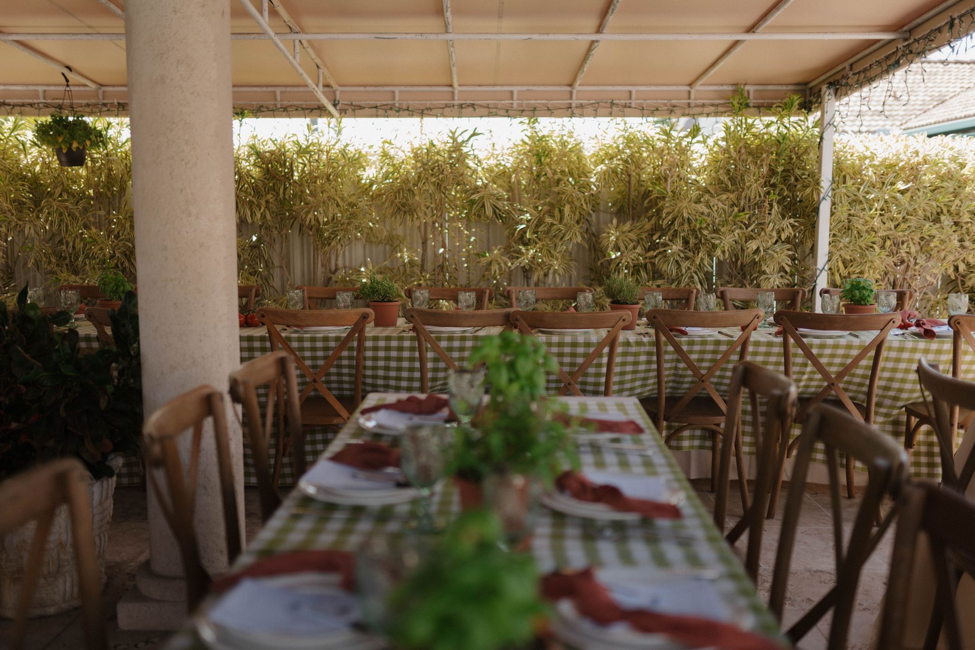 A restaurant with tables and chairs set up for a meal.