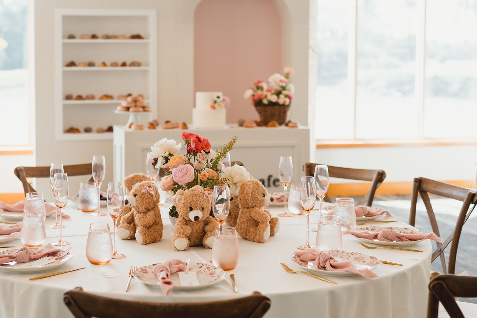 A long table in a restaurant with flowers on it