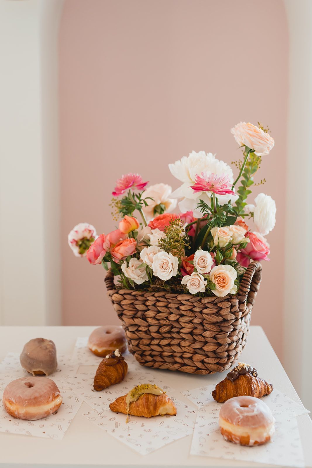 A long table with plates, utensils, and flowers on it.