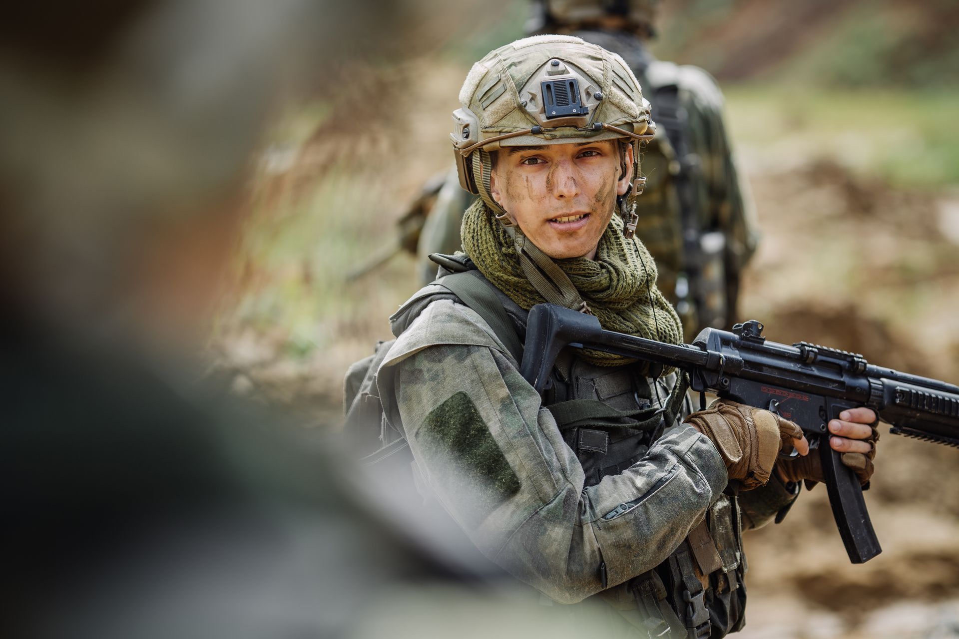 Portrait of a ranger in the battlefield with a rifle.