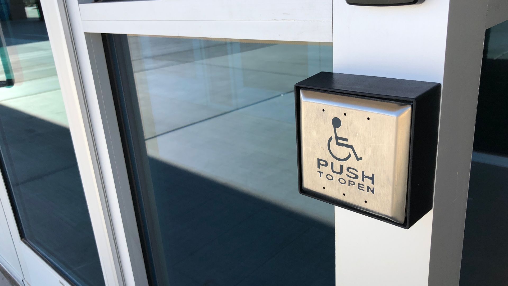 Wheelchair accessible door button with