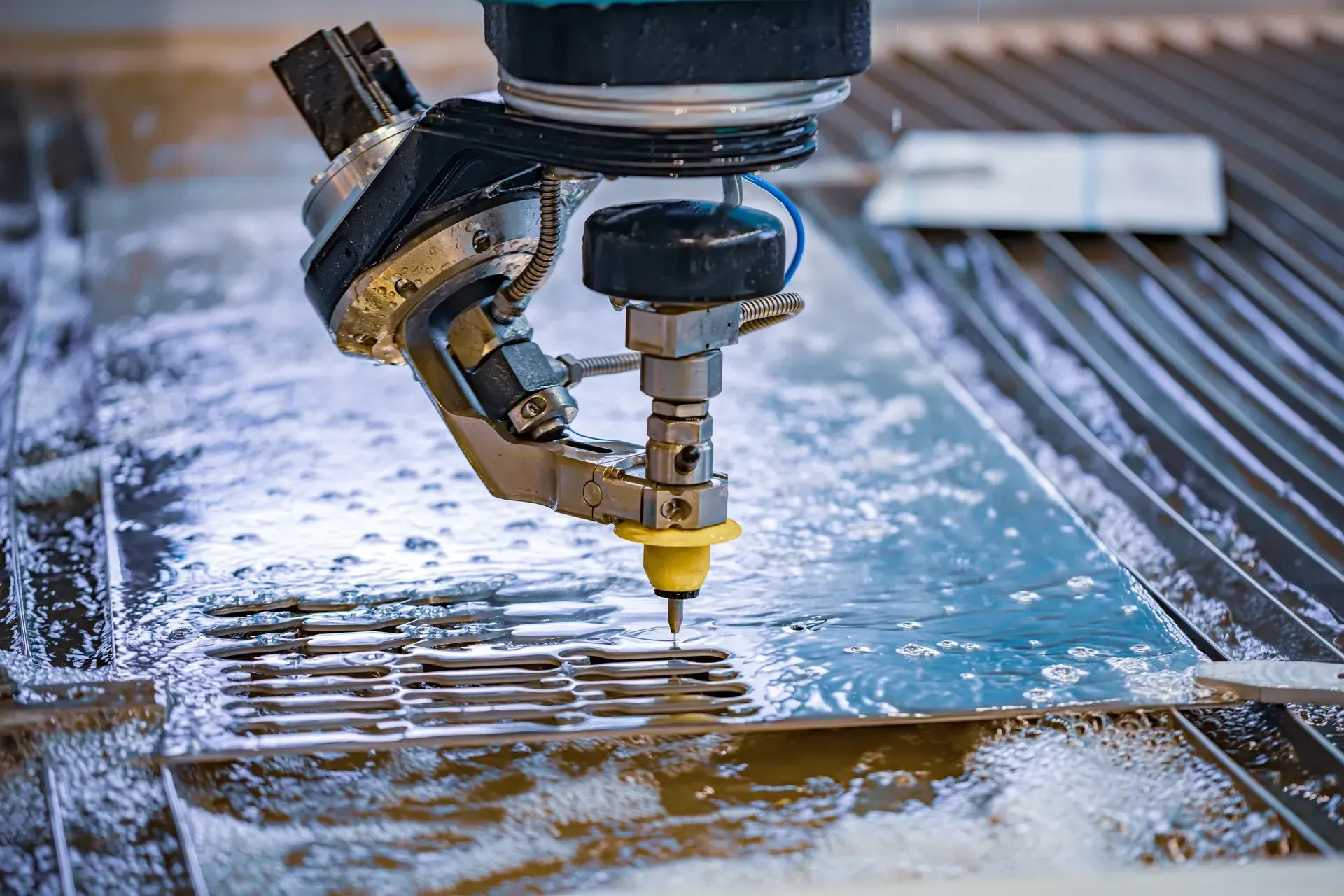 A machine is cutting a piece of metal with water.