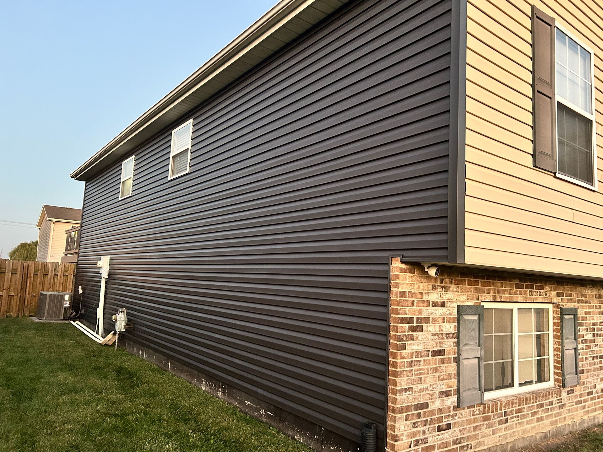 Photo of a completed vinyl siding project by Fast Track Contracting