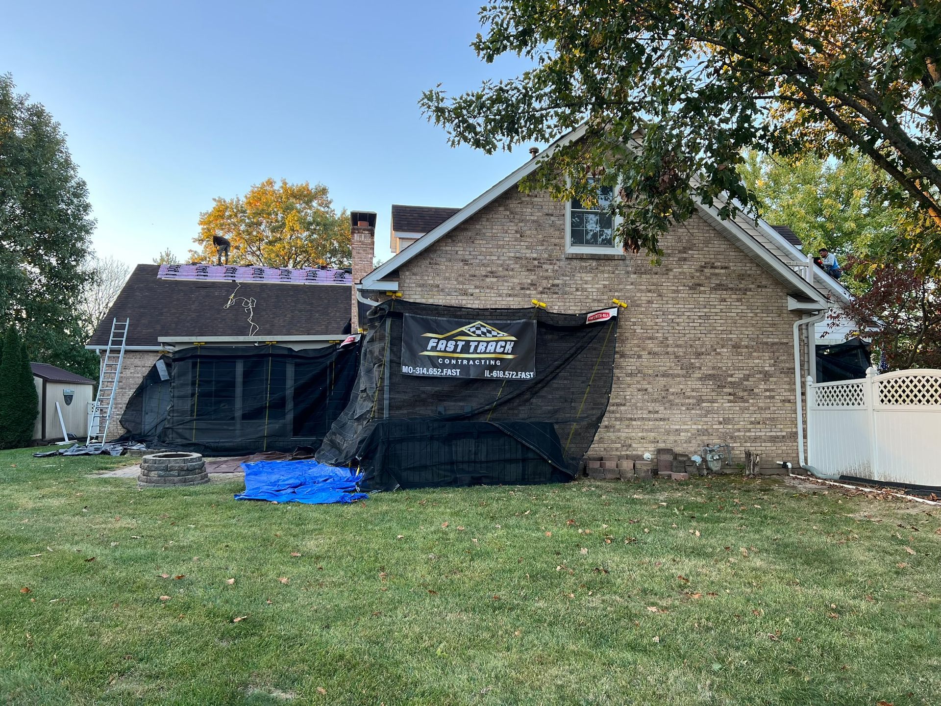 Photo of Fast Track Contracting repairing a storm damaged roof on a residential home