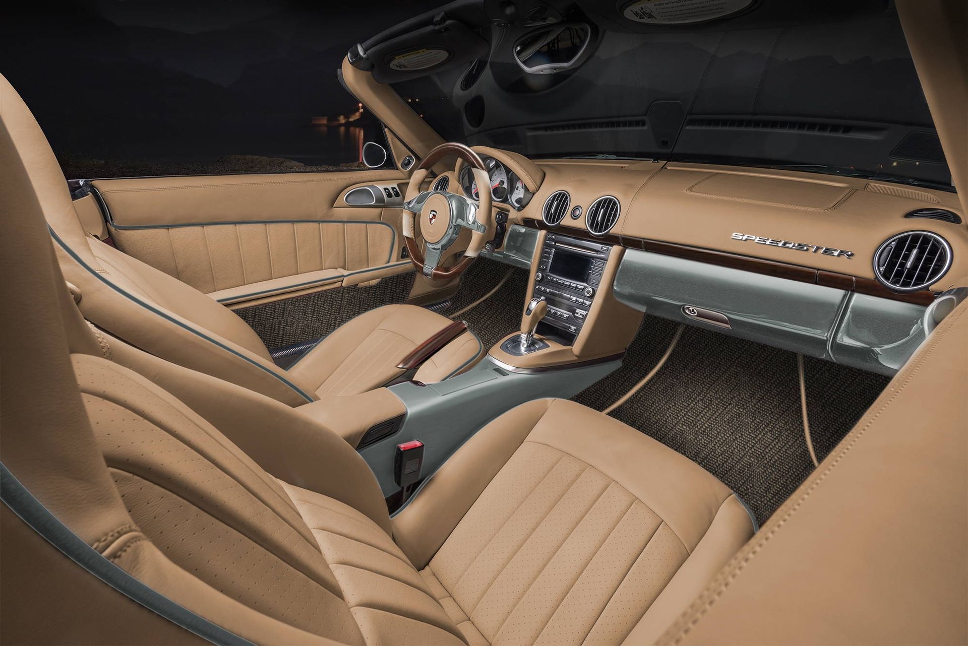 Tan leather luxury car interior with chrome steering wheel and center console