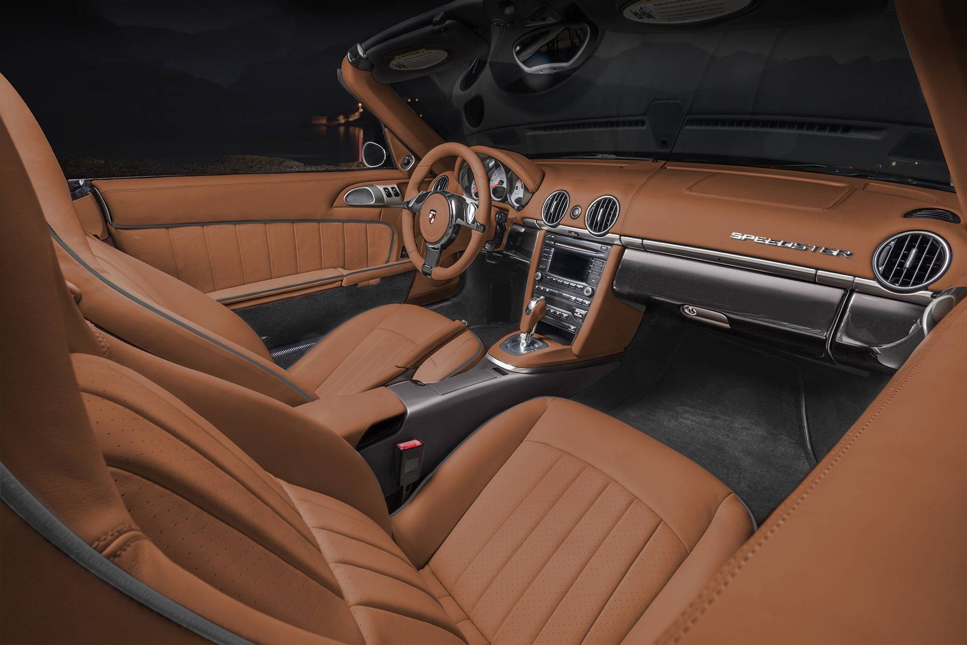 Luxury car interior with tan leather seats, wood trim, and a center console dashboard view