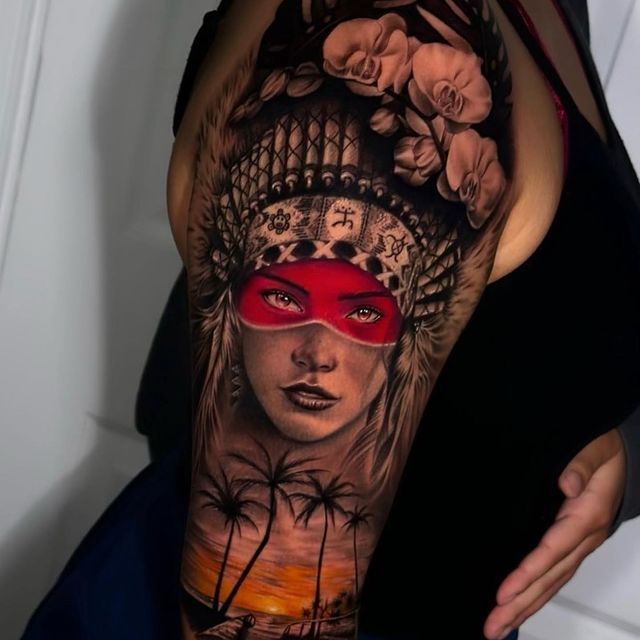 A woman has a tattoo of a woman wearing a red mask on her arm.