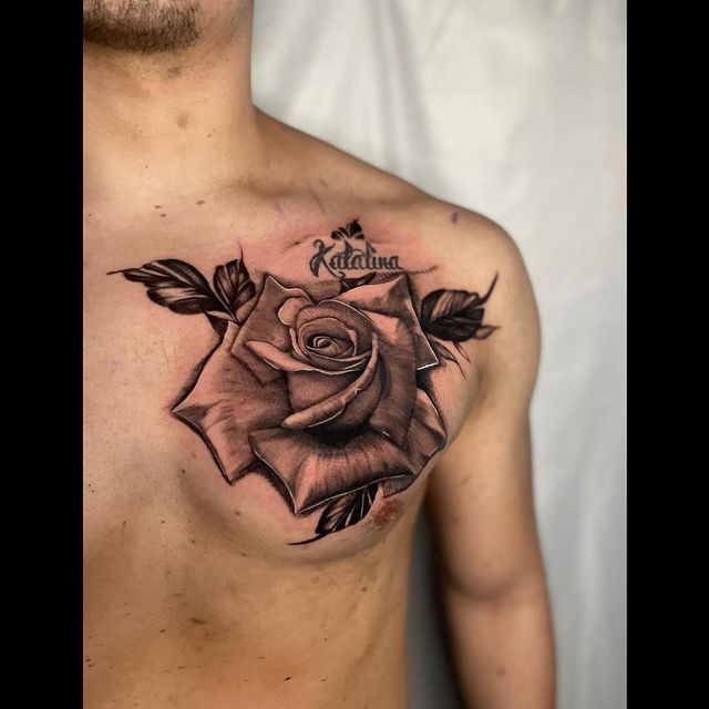 A man has a tattoo of a rose on his chest.