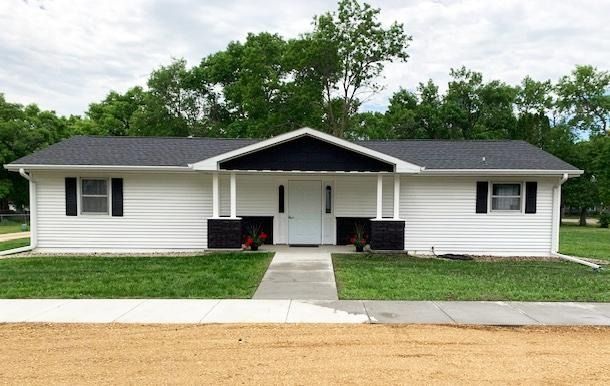 Tan building with blue shingle roof,