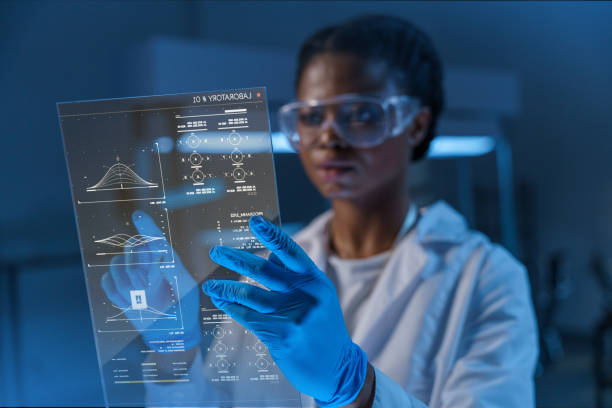 Scientist in lab coat and gloves examining a transparent digital display with data charts in a lab