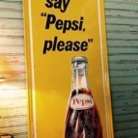 Pepsi sign with a bottle and the text “say ‘Pepsi, please’” on a yellow background