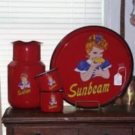 Red Sunbeam kitchenware with vintage girl logo displayed on a shelf