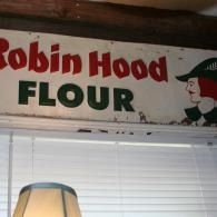 Robin Hood Flour sign above a window with blinds and a lamp below