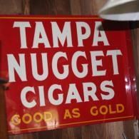 Red Tampa Nugget Cigars sign with the slogan “Good as Gold” in gold letters