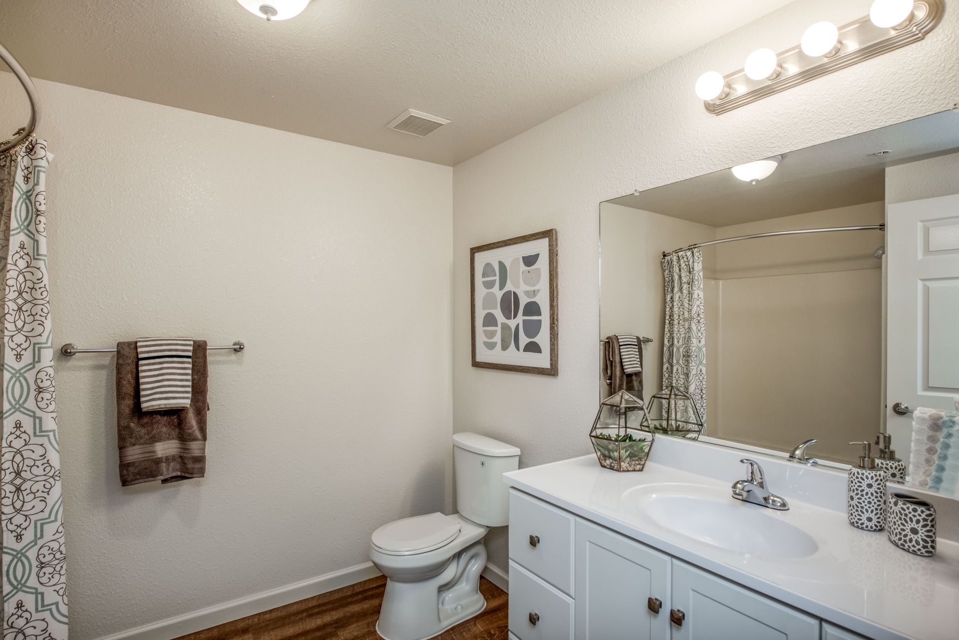 a bathroom with a toilet , sink , and mirror .