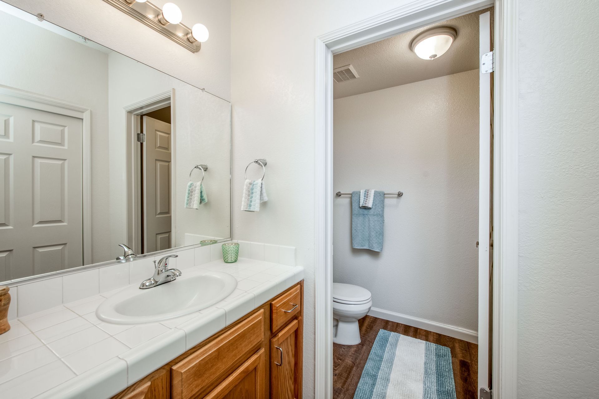 a bathroom with a sink , toilet , and mirror .