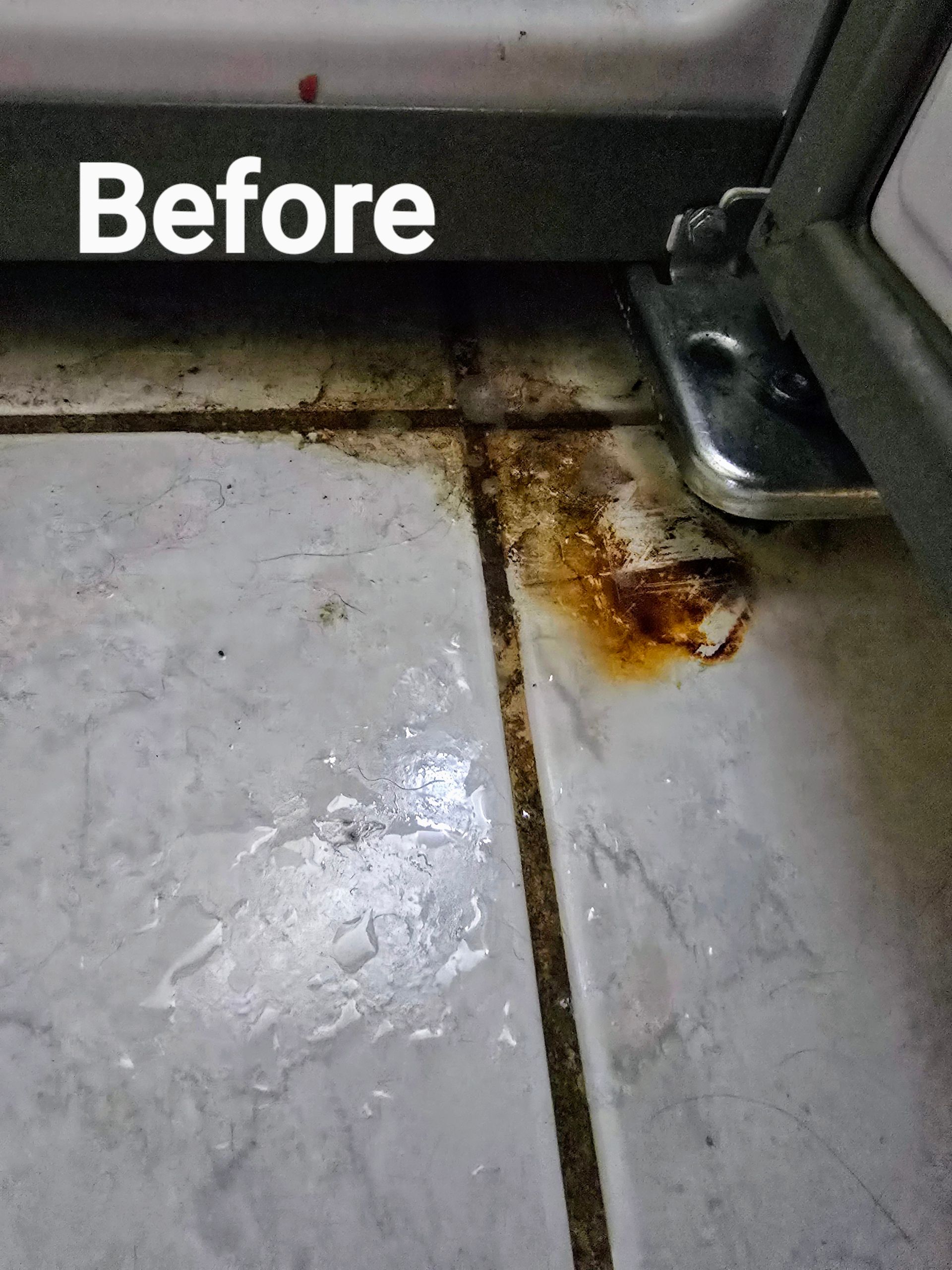 A picture of a dirty tile floor before being cleaned.