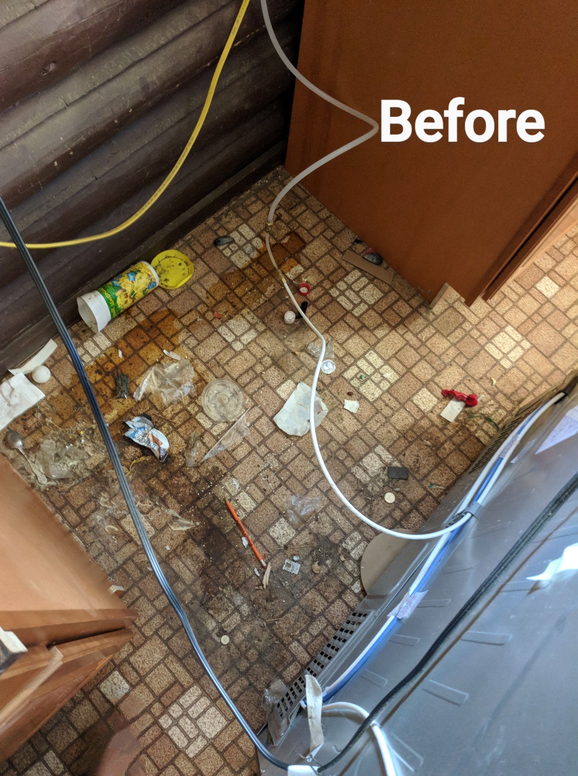 A before picture of a messy kitchen floor