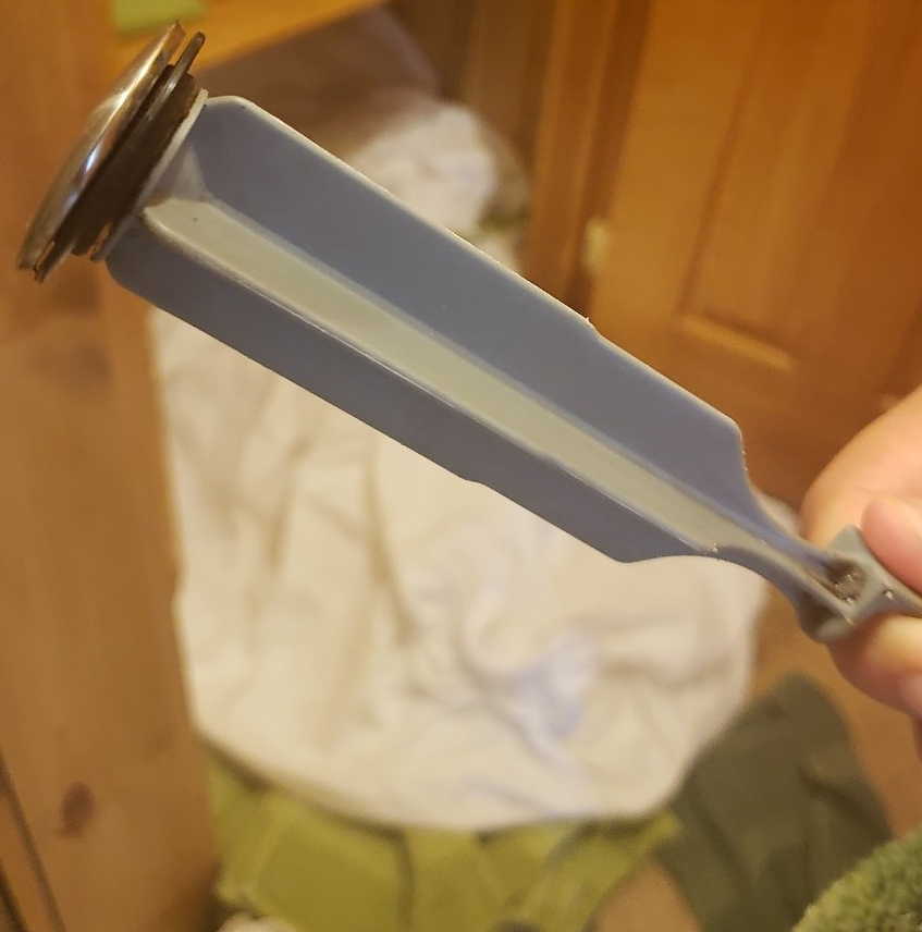 A person is holding a blue object in their hand