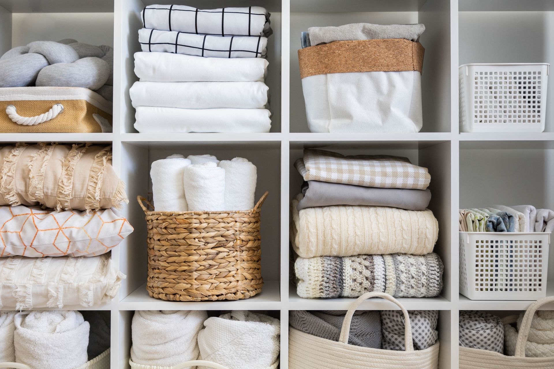 A closet filled with lots of clothes and baskets.