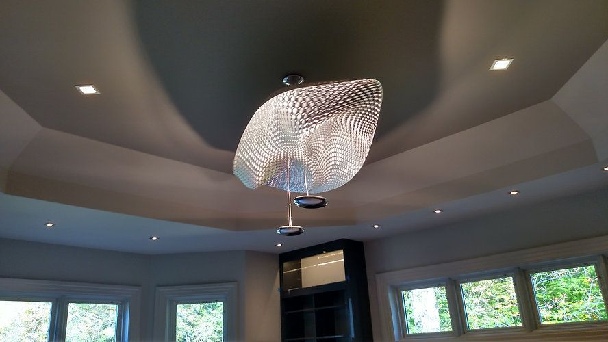 A large chandelier is hanging from the ceiling of a living room.