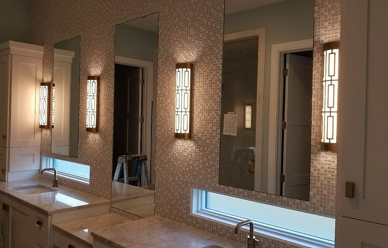 A bathroom with a lot of mirrors and lights