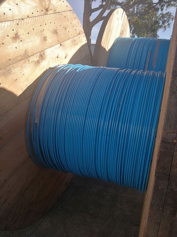 Two spools of blue wire are sitting next to each other