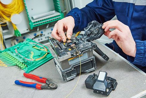 A man is working on a piece of equipment on a table.