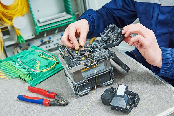 A man is working on a piece of equipment on a table.