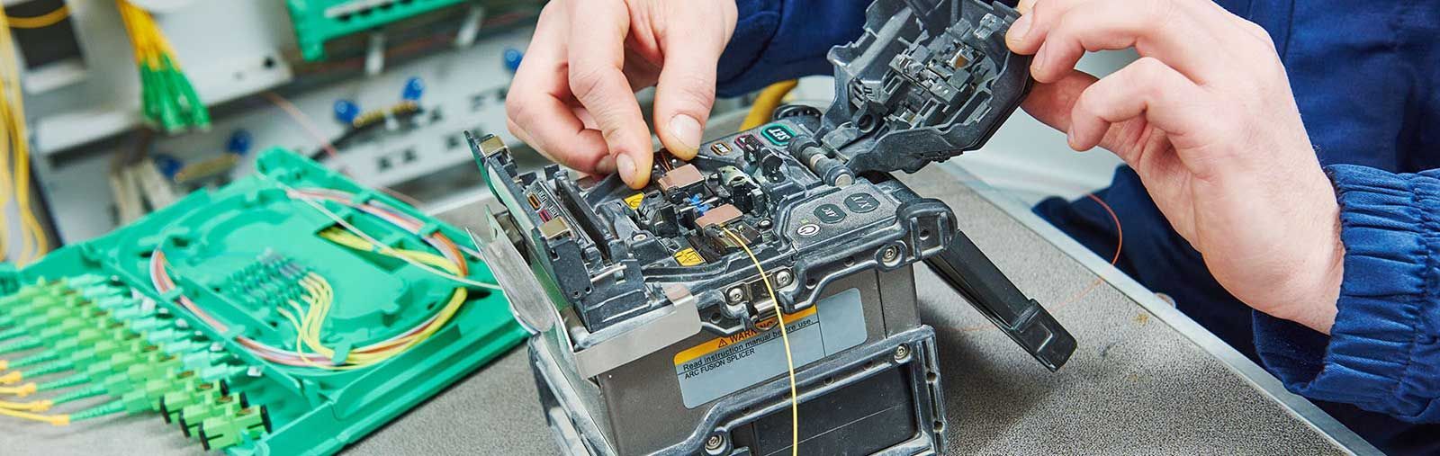 A person is working on a piece of electronic equipment.