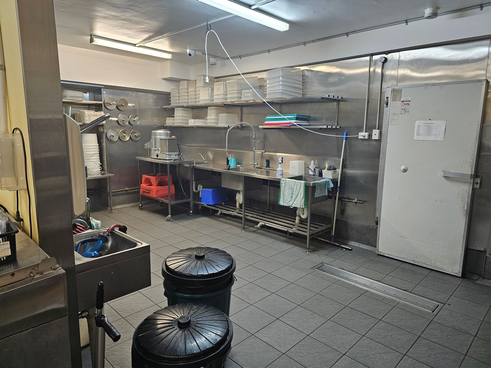 A kitchen with a lot of stainless steel appliances and a sink.