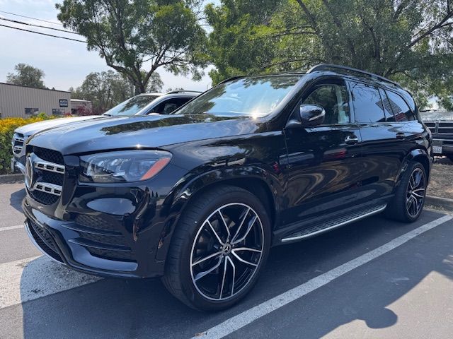 Black Mercedes SUV parked in a lot on a sunny day