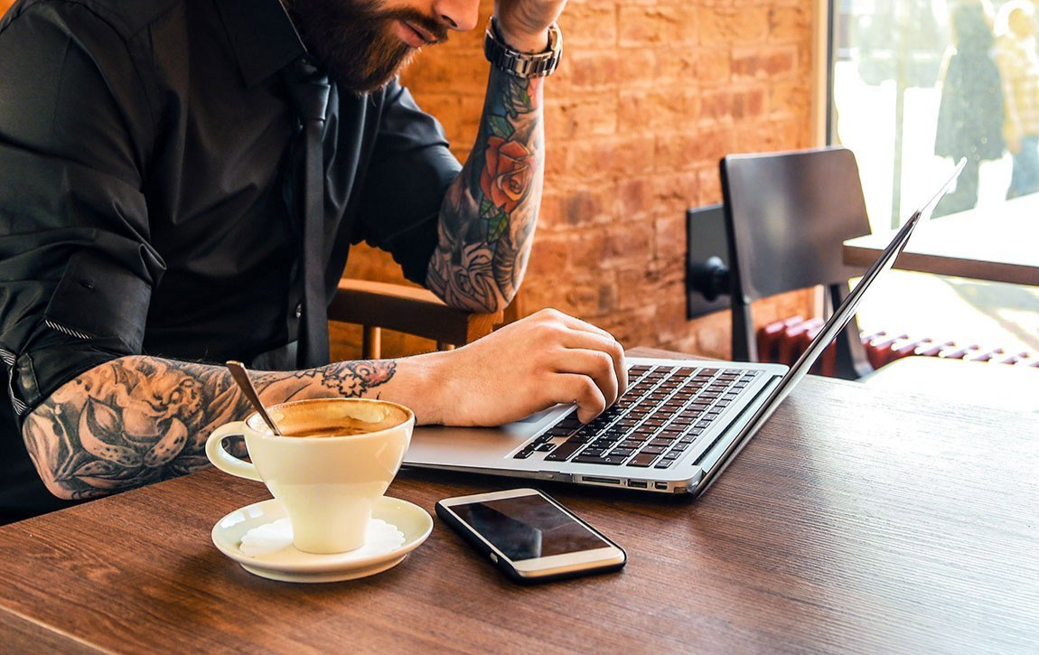 Business Owner working on laptop at cafe