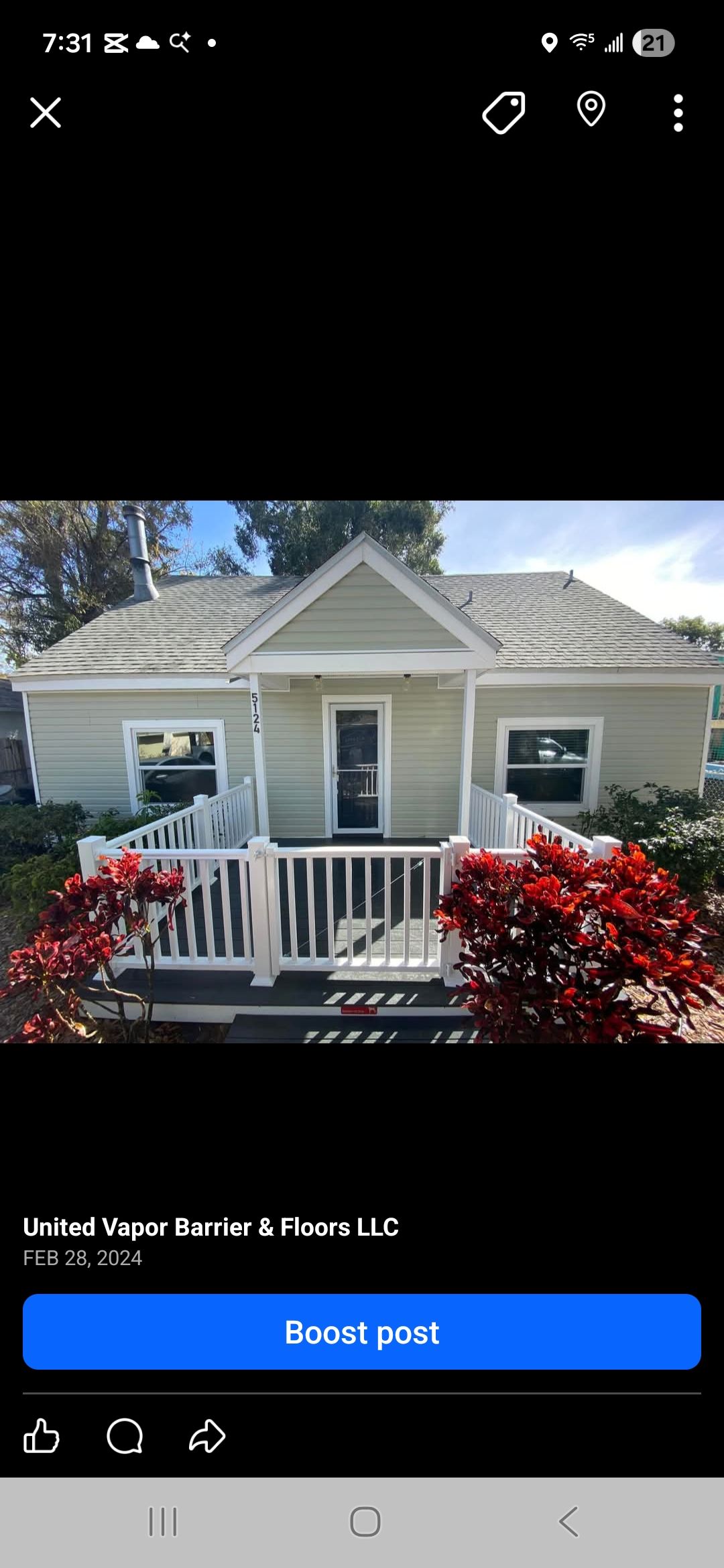 Small, light green house with white trim, red bushes, and a white picket fence on the porch. Small, light green house with white trim, red bushes, and a white picket fence on the porch.