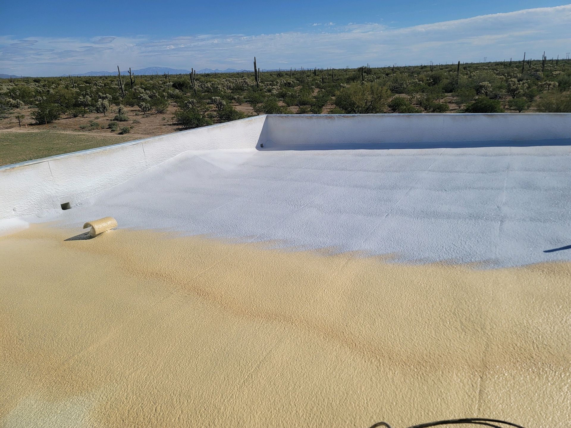 White-lined concrete basin in a dry desert landscape under a blue sky