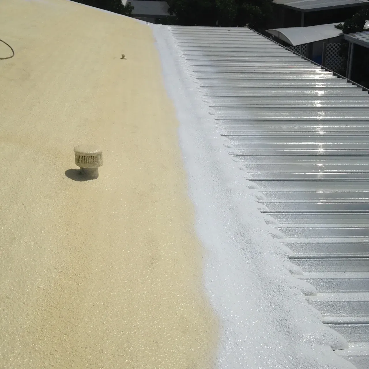 Yellow and silver corrugated roof with a small vent pipe on the left side