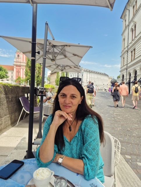 A person with long dark hair, wearing a patterned shawl and necklace — Vedic Meditation & Coherence Personal Counselling in Slovenia