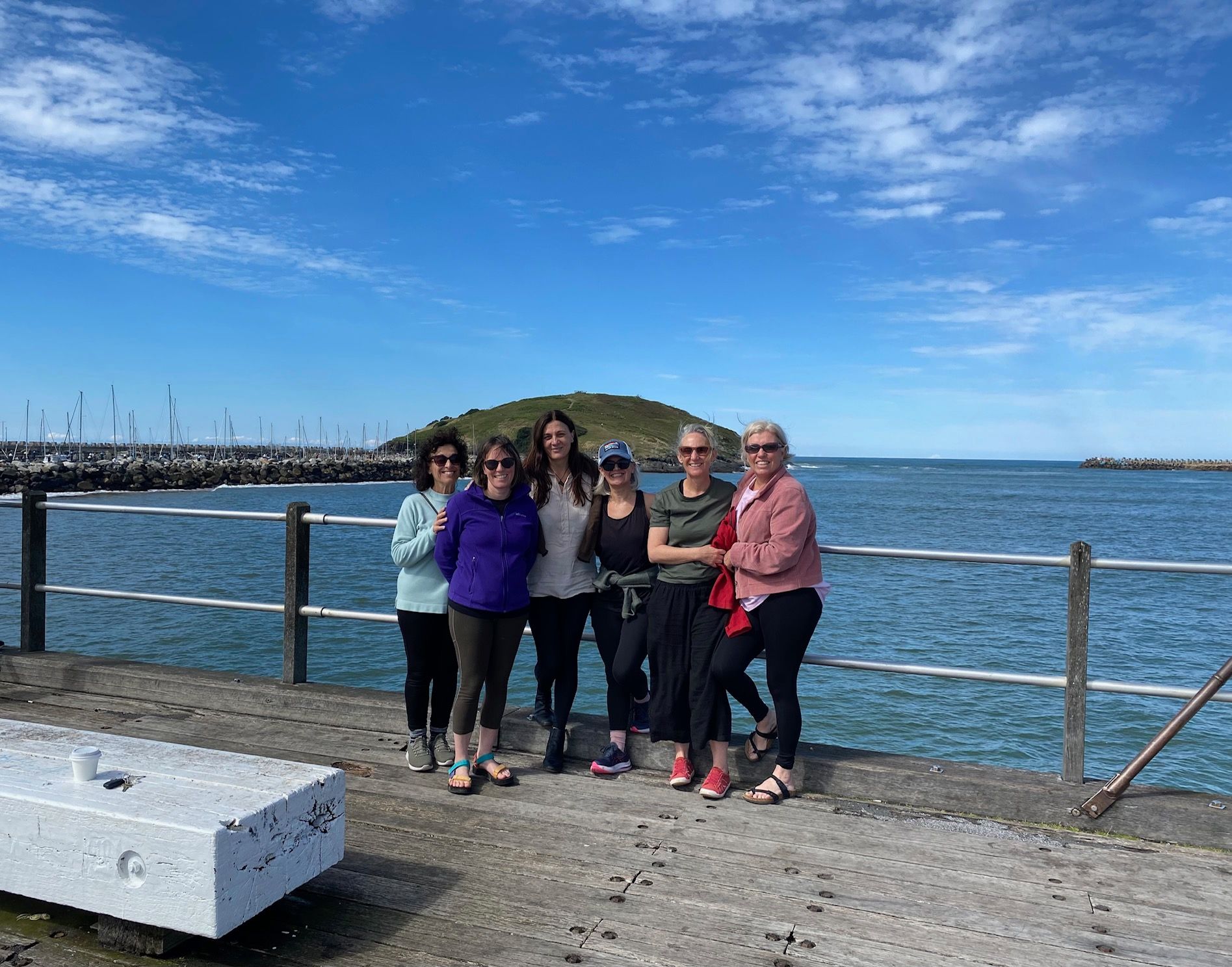 Six people stand in a line on a concrete pier — Vedic Meditation & Coherence Personal Counselling in Coffs Harbour, NSW