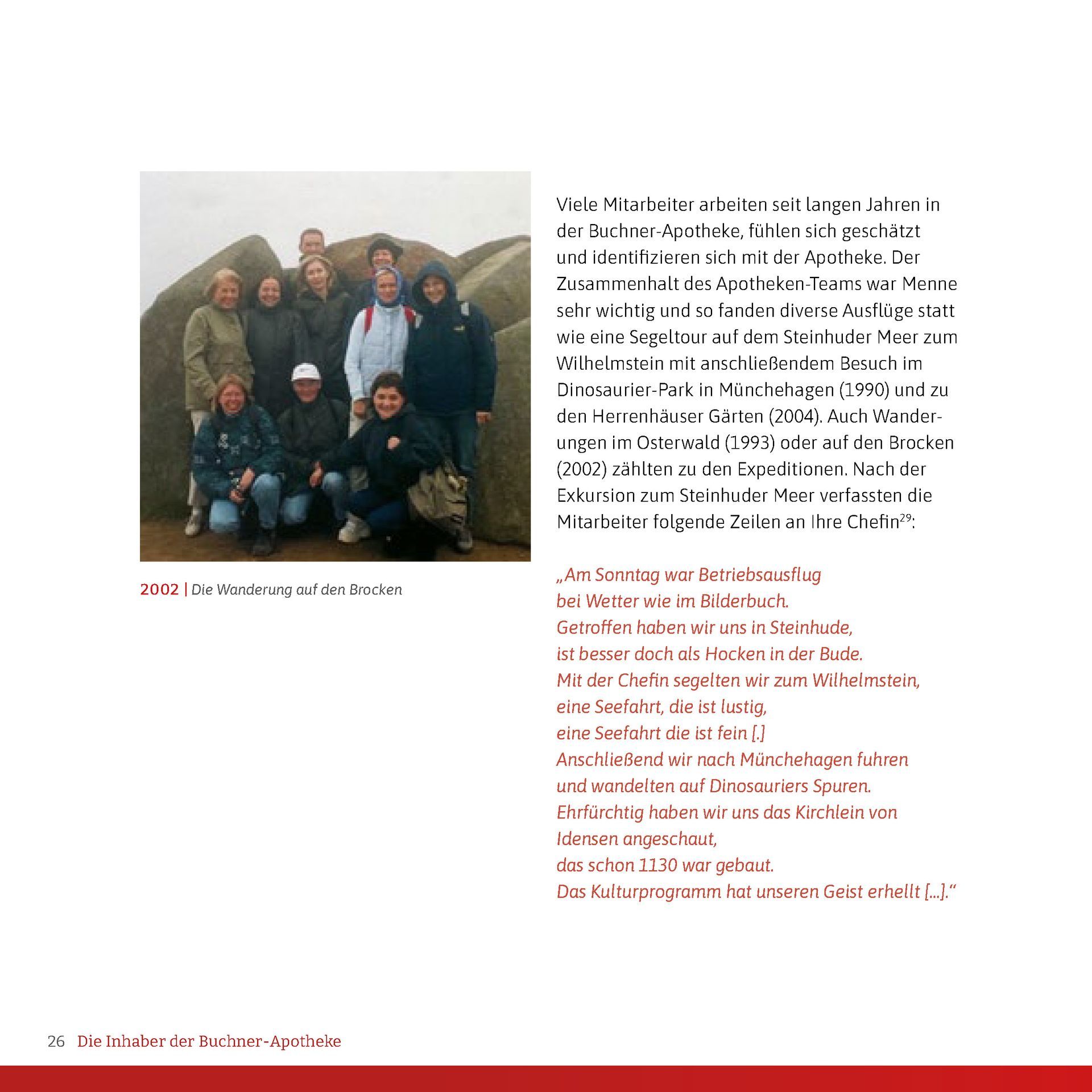 Eine Gruppe von Menschen posiert vor einem großen Felsen für ein Foto.