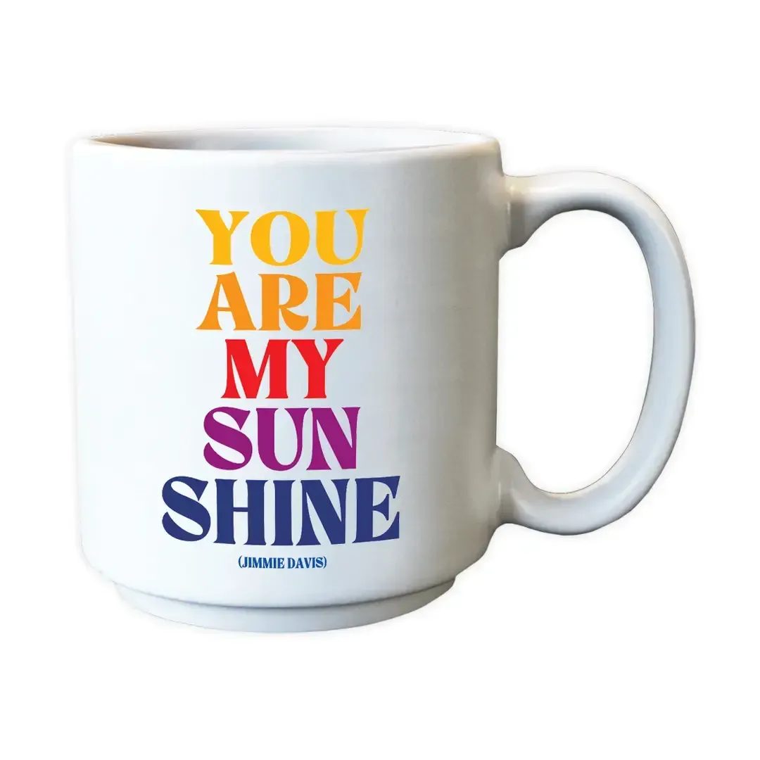White mug with colorful stacked text reading “YOU ARE MY SUNSHINE.”