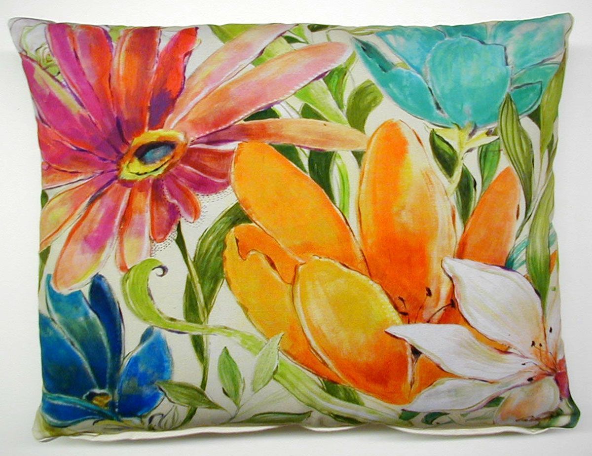 Colorful floral pillow with painted pink, orange, blue, and teal flowers and green leaves