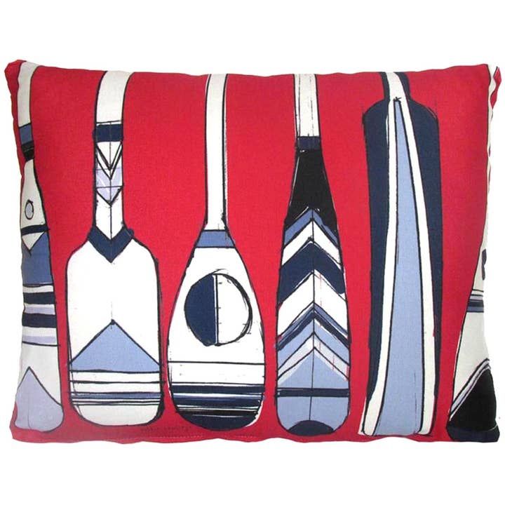 Red decorative pillow with illustrated rowing oars on a white background